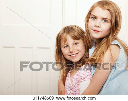 Portrait of two girls hugging View Large Photo Image Stock Photo - Portrait of two girls hugging. Fotosearch