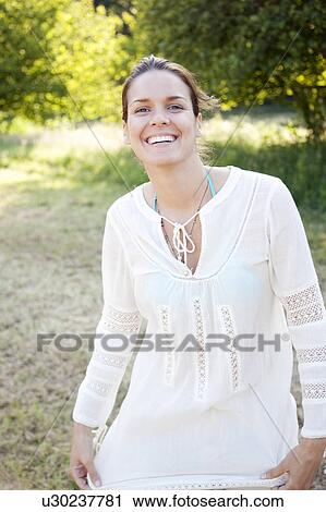 Portrait of woman smiling in countryside View Large Photo Image Stock Image - Portrait of woman smiling in countryside. Fotosearch