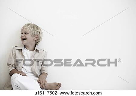 Stock Image - Portrait of young boy laughing. Fotosearch