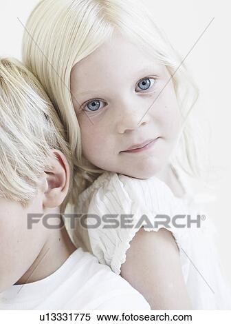 Stock Photography - Portrait young girl leaning on brother. Fotosearch