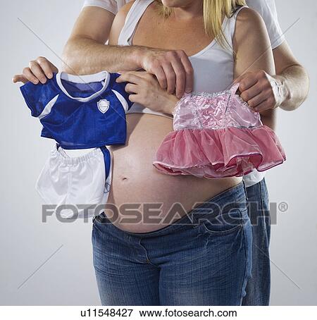 pregnant woman and man with baby clothes View Large Photo Image Stock Photo - pregnant woman and man with baby clothes. Fotosearch