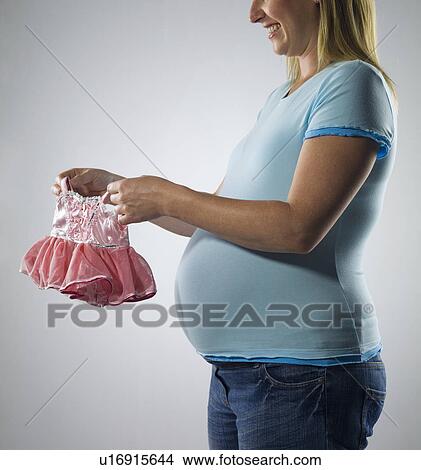 Picture - pregnant woman with baby fairy dress. Fotosearch