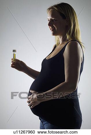 pregnant woman with sample bottle View Large Photo Image Stock Image - pregnant woman with sample bottle. Fotosearch