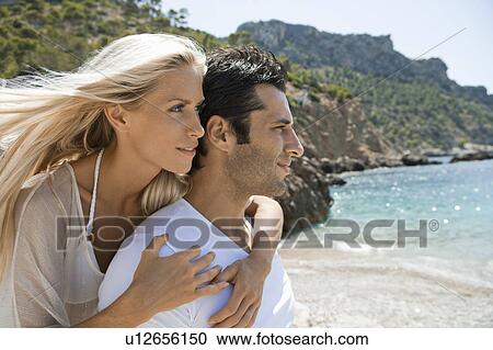 Profile of of a young beach couple View Large Photo Image Stock Image - Profile of of a young beach couple. Fotosearch