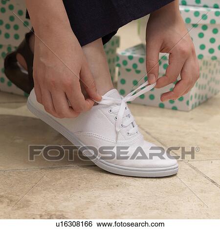 Stock Photograph - Putting on a shoe. Fotosearch