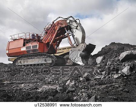 Stock Image - Red Digger Working In Coal Mine. Fotosearch