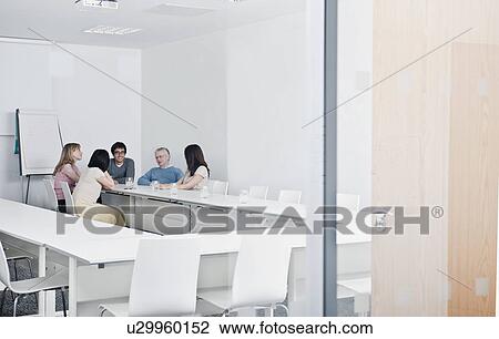 Stock Image - relaxed work group in meeting room. Fotosearch