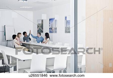 Stock Photograph - relaxed work group in meeting room. Fotosearch