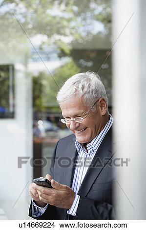 Senior Businessman Using Cellphone View Large Photo Image Picture - Senior Businessman Using Cellphone. Fotosearch