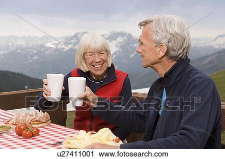 Stock Image - senior couple eating in mountains. Fotosearch