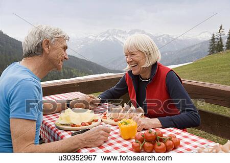 senior couple eating in mountains View Large Photo Image Stock Photo - senior couple eating in mountains. Fotosearch