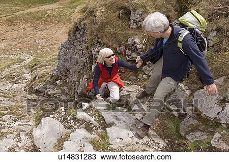 Stock Image - senior couple hiking in mountains. Fotosearch