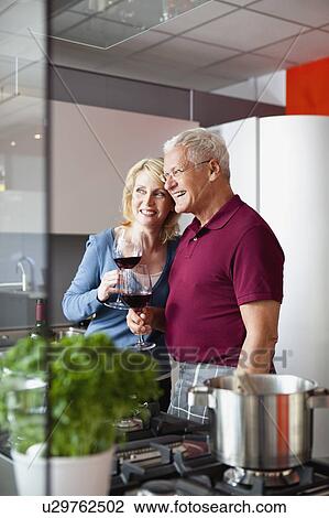 Stock Image - Senior Couple Holding Wine Glasses. Fotosearch
