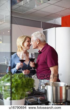 Senior Couple Kissing in Kitchen View Large Photo Image Picture - Senior Couple Kissing in Kitchen. Fotosearch