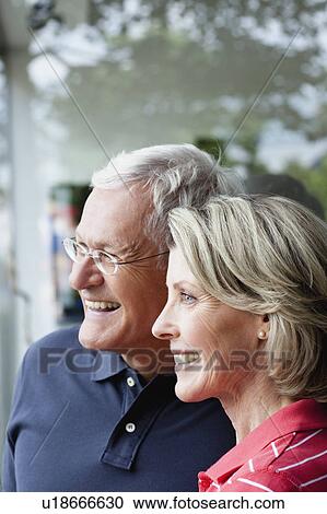 Stock Image - Senior Couple Looking At Window. Fotosearch