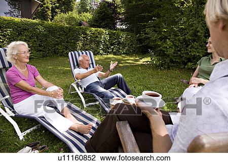 Stock Image - senior couple, man, woman sit together. Fotosearch