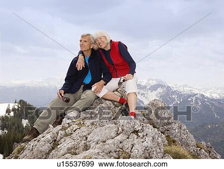 Stock Photo - senior couple on mountain summit. Fotosearch