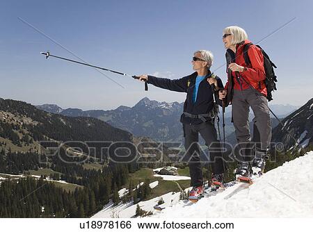 Stock Photograph - senior couple on ski tour in mountains. Fotosearch