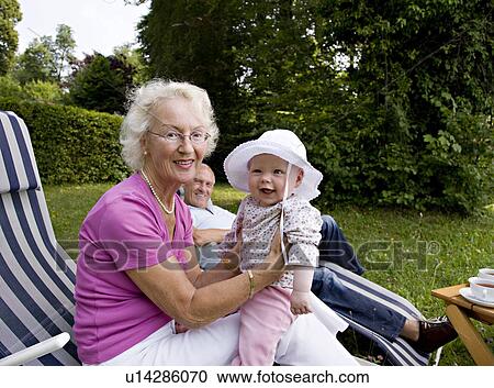 Stock Image - senior couple with grandchild. Fotosearch