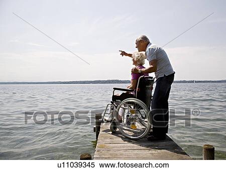 Stock Photography - senior man and woman in wheelchair. Fotosearch