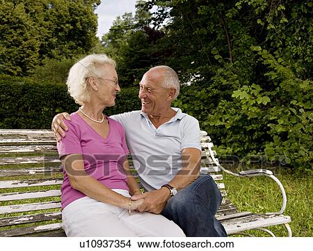 Picture - senior man and woman on old bench. Fotosearch