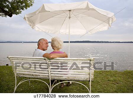 Stock Photo - senior man and woman on old bench. Fotosearch