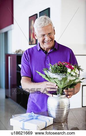 Stock Photo - Senior Man Arranging Flowers. Fotosearch