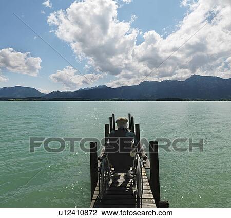 Senior man in wheelchair by lake View Large Photo Image Stock Image - Senior man in wheelchair by lake. Fotosearch