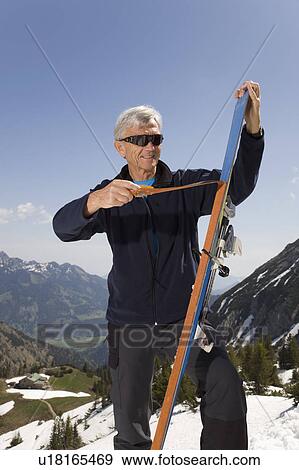 Stock Photo - senior man on ski tour in mountains. Fotosearch