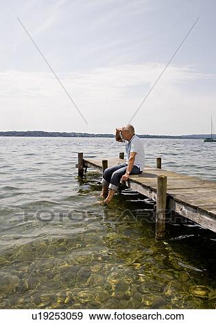 senior man sitting on pier at lake View Large Photo Image Stock Photo - senior man sitting on pier at lake. Fotosearch