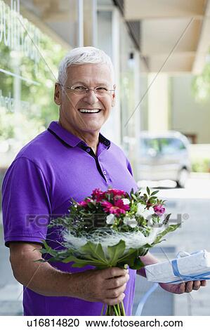 Stock Image - Senior Man With Gifts. Fotosearch
