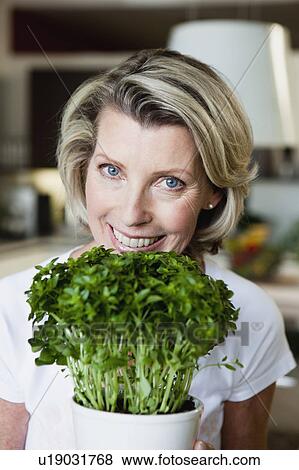 Senior Woman Holding Plant View Large Photo Image Stock Photo - Senior Woman Holding Plant. Fotosearch