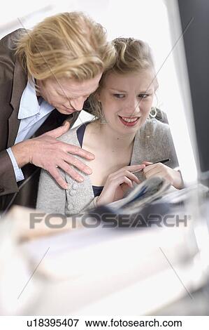 Stock Photo - sexual harassment in office. Fotosearch