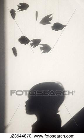 Stock Image - shadow of boy and mobile toy. Fotosearch