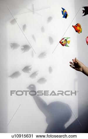 Stock Image - shadow of boy playing with mobile toy. Fotosearch