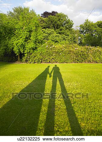 Stock Photography - Shadow of couple holding hands. Fotosearch