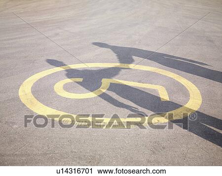 Stock Image - Shadow Of Handshake On Tarmac. Fotosearch