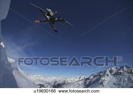 Skier jumping into the air. View Large Photo Image Stock Photograph - Skier jumping into the air.. Fotosearch