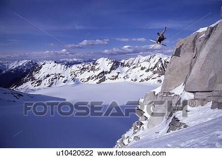 Skier jumping off a cliff View Large Photo Image Stock Image - Skier jumping off a cliff. Fotosearch