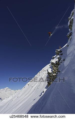 Skier jumping off a cliff. View Large Photo Image Stock Photo - Skier jumping off a cliff.. Fotosearch
