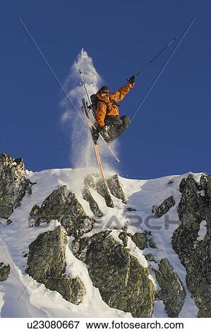 Skier jumping off rocks. View Large Photo Image Stock Photo - Skier jumping off rocks.. Fotosearch