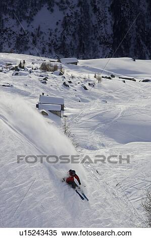 Stock Photography - Skier turning down a slope.. Fotosearch