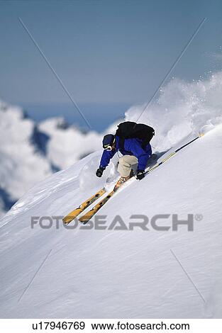 Stock Photo - Skier turning down a snow slope. Fotosearch