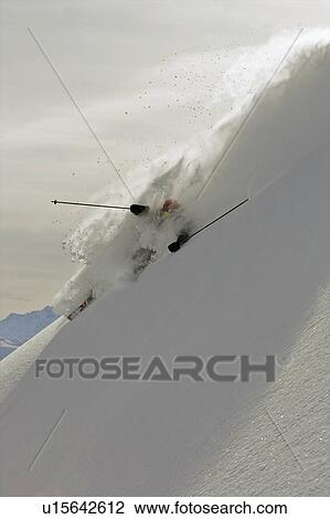 Stock Image - Skier turning in deep powder snow.. Fotosearch