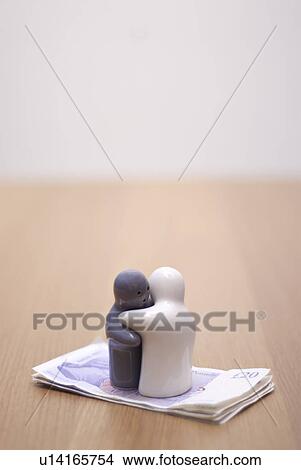 Picture - small figures on money. Fotosearch