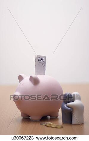 Stock Image - small figures with piggy bank. Fotosearch