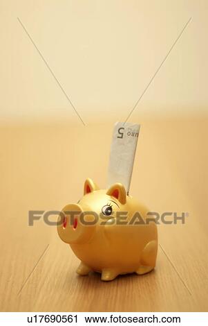 Stock Image - small piggy bank with note in it. Fotosearch