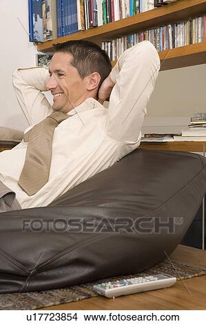 Picture - smiling man watching TV. Fotosearch