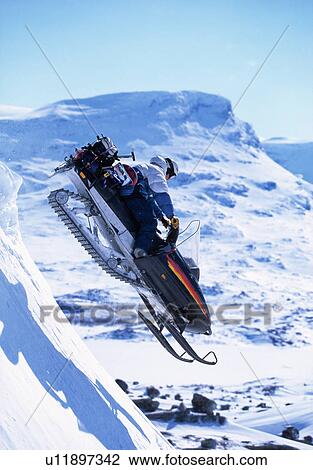 Snowboarder jumping on a skidoo. View Large Photo Image Stock Image - Snowboarder jumping on a skidoo.. Fotosearch