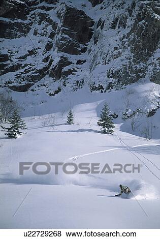 Stock Photo - Snowboarder turning in powder snow. Fotosearch